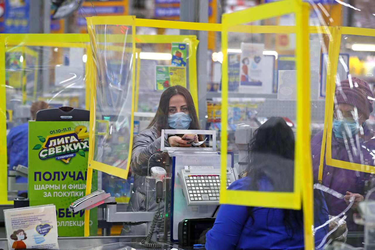 A customer wears a face mask by a cash desk in a Lenta supermarket amid the ongoing COVID-19 coronavirus pandemic in Russia.