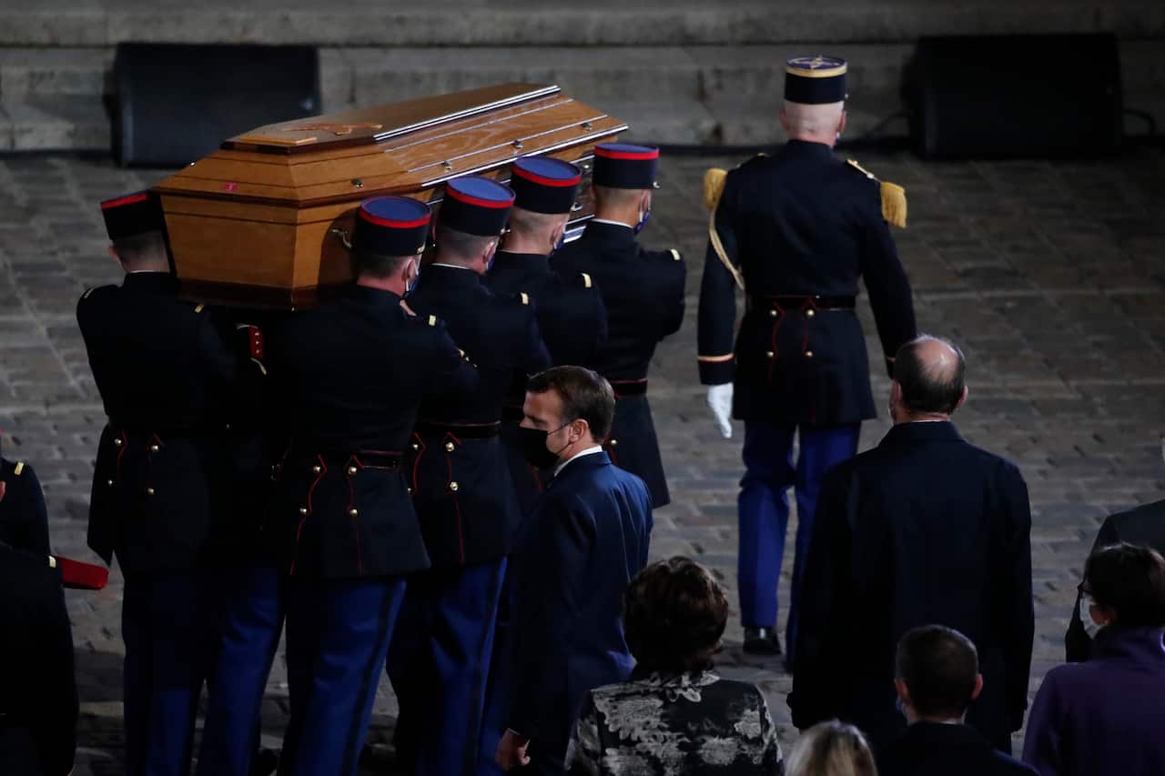 The coffin of slain teacher Samuel Paty is carried in the courtyard of the Sorbonne university during a national memorial event, 21 October, 2020 in Paris.