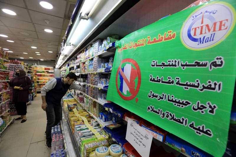 A spot of French products is covered with a placard reading in Arabic 'French products are being boycotted for the sake of the Prophet Muhammad peace upon him',
