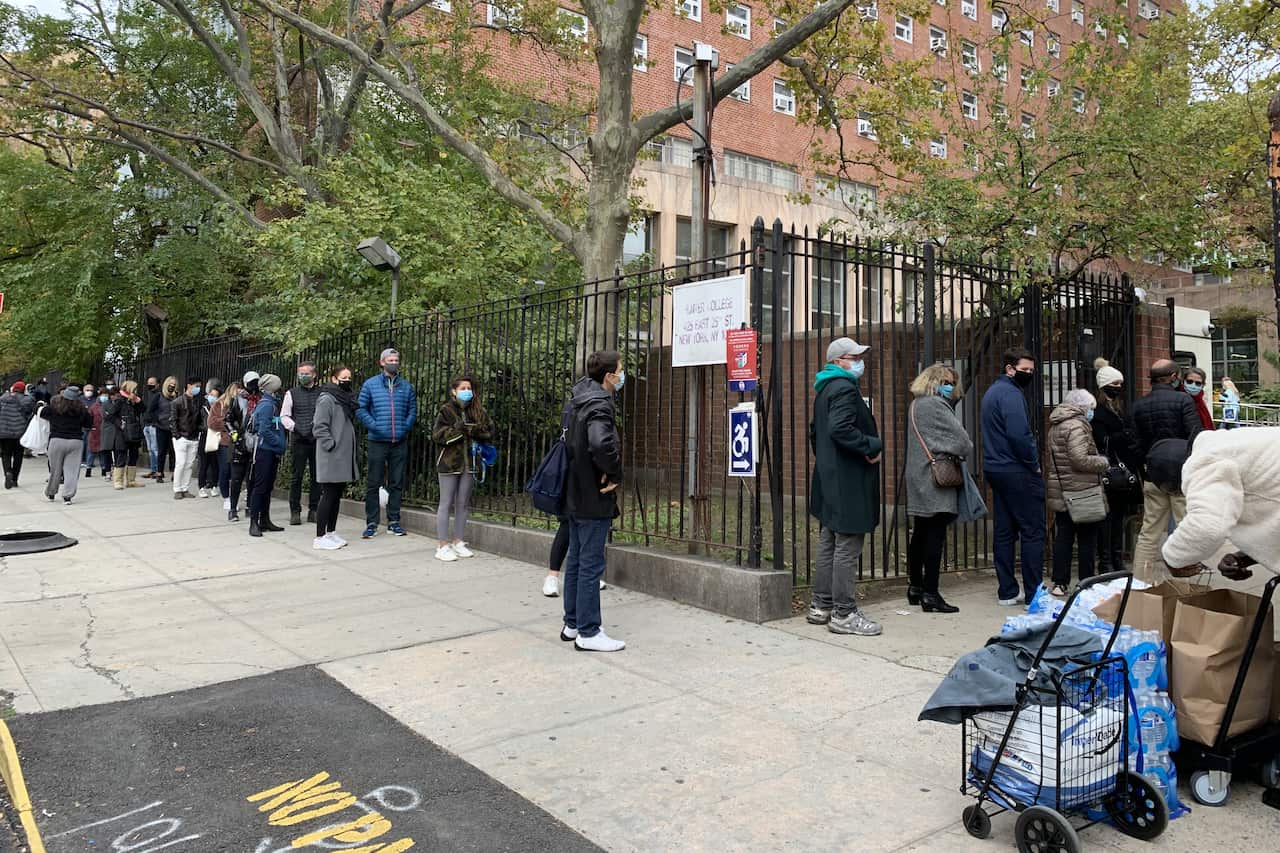 People queue outside an early voting station in Manhattan a week before the US presidential election.