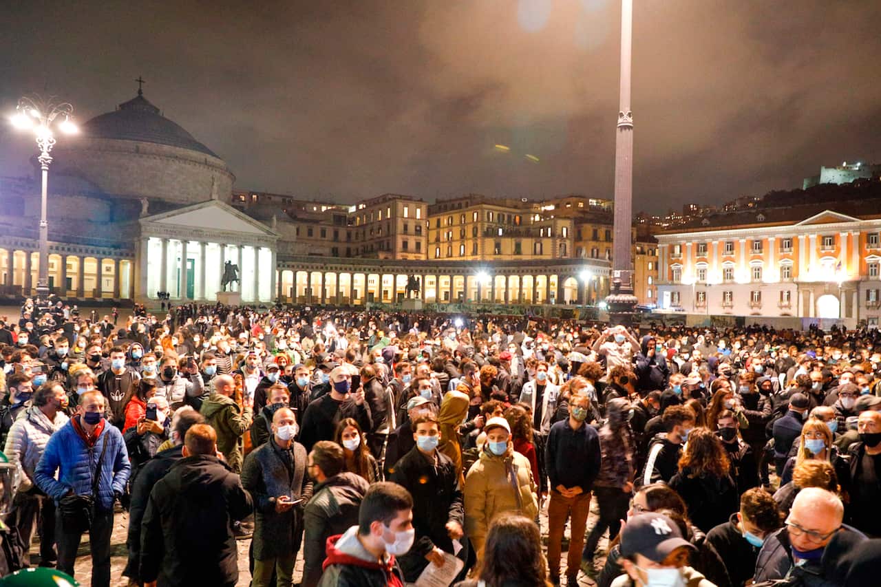 People protest the government restriction measures to curb the spread of COVID-19 in Naples on 26 October. 