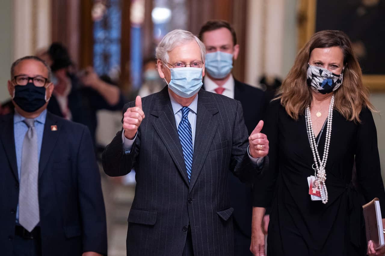 Republican Senate Majority Leader Mitch McConnell gives the thumbs-up after the Senate voted to confirm Judge Amy Coney Barrett to the US Supreme Court. 