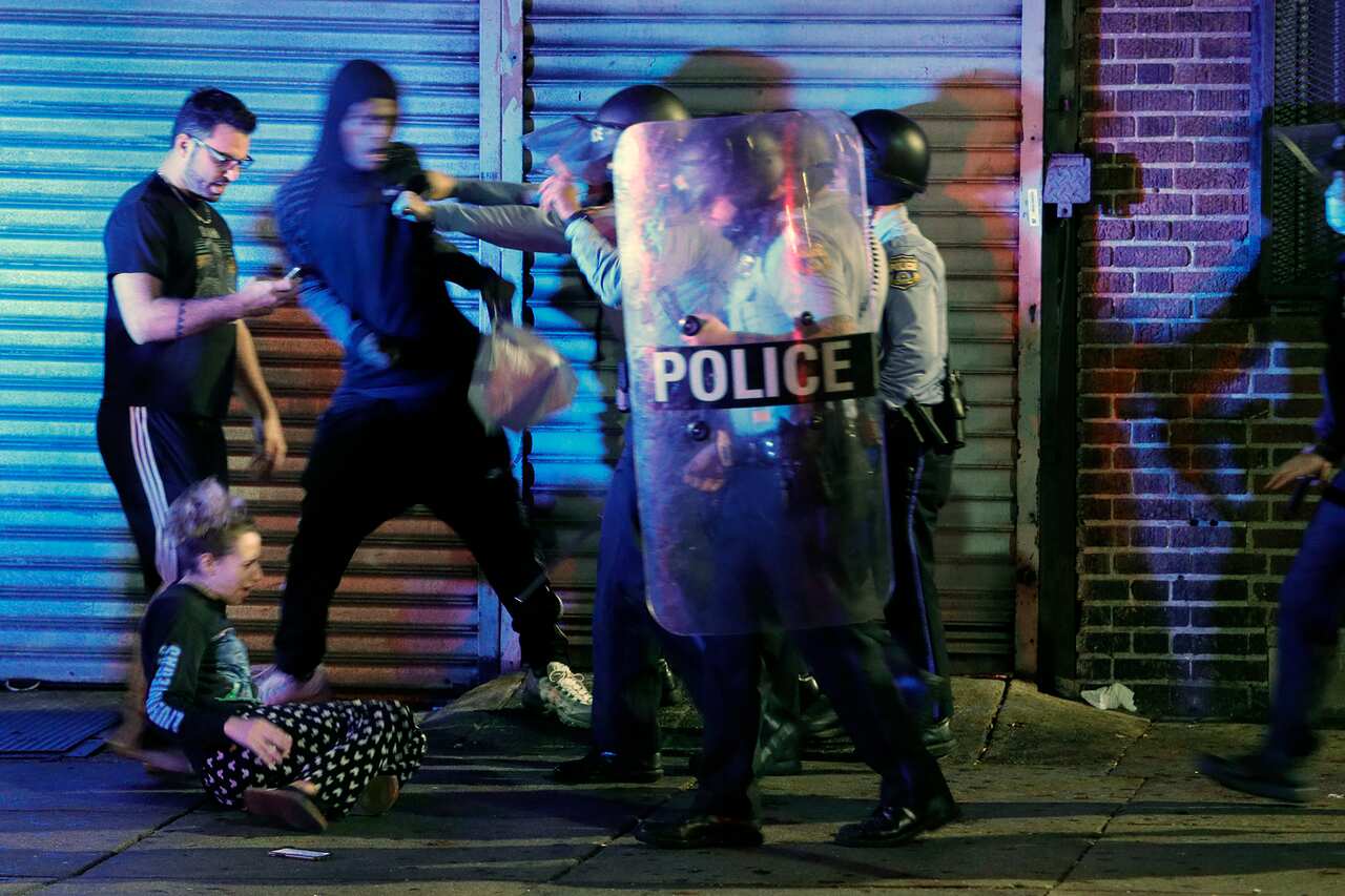 Police push people back during a violent protest after police shot and killed a 27-year-old Black man on a Philadelphia street, early Tuesday, Oct. 27, 2020. (Elizabeth Robertson/The Philadelphia Inquirer via AP)