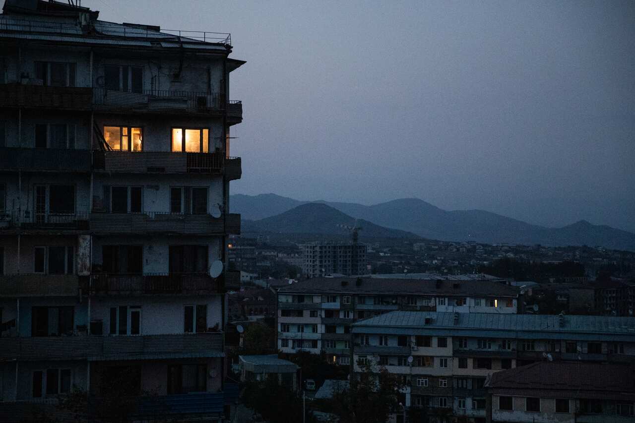 Windows lit at night in an apartment building in the city of Stepanakert.
