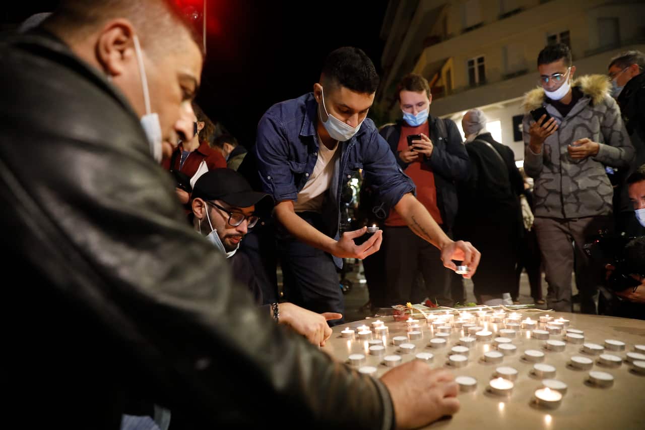  Young people light candles near the entrance of the Notre Dame Basilica church in Nice, France, 29 October 2020, following a knife attack. 