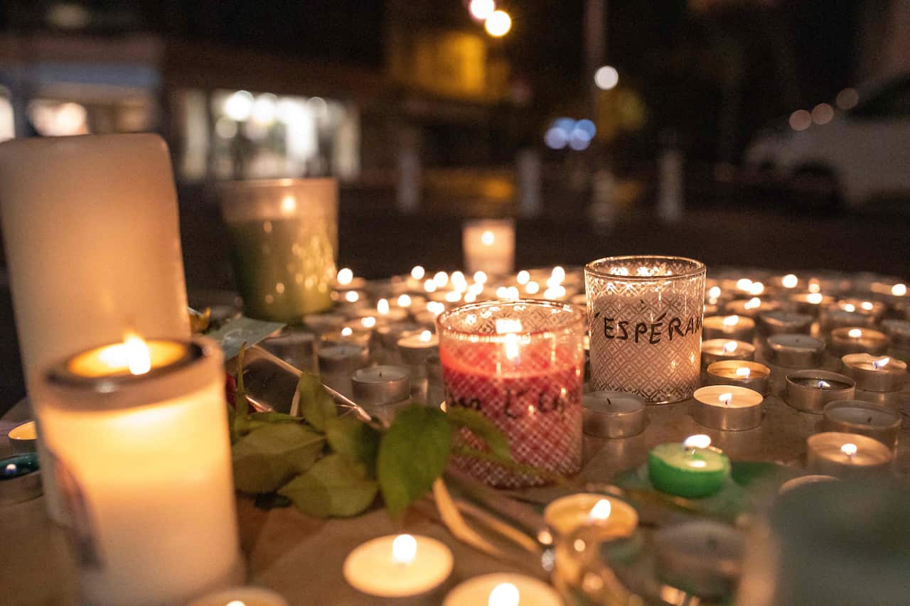 People pay tribute at night in front of Notre Dame Basilica on October 29, 2020 in Nice.