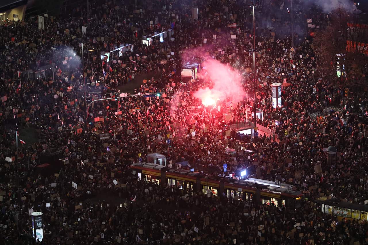 Thousands of people gather in the centre of Warsaw as they take part in the protest against the tightening of abortion laws in Poland, 30 October 2020. 
