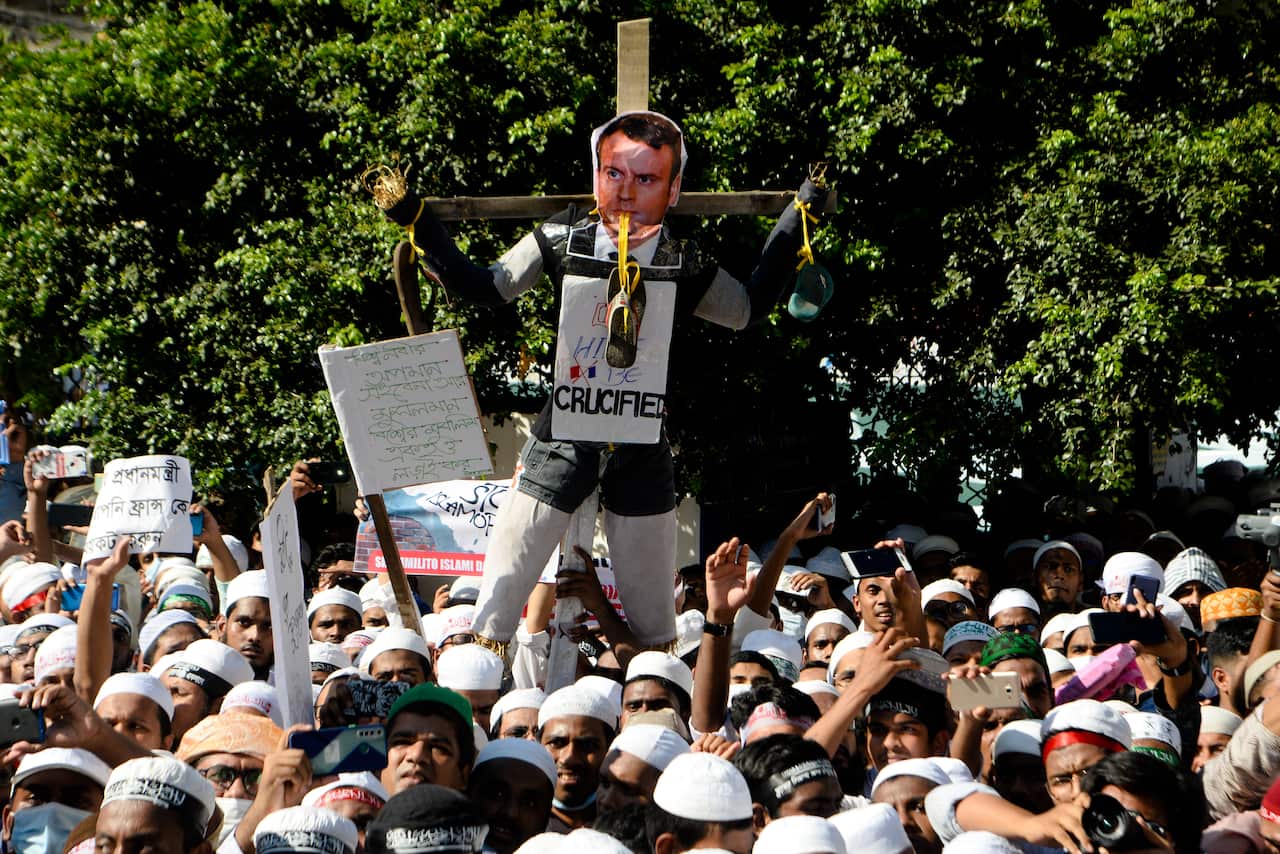 Protesters in Dhaka, Bangladesh are seen with a figure of French President Emmanuel Macron attached to a crucifix