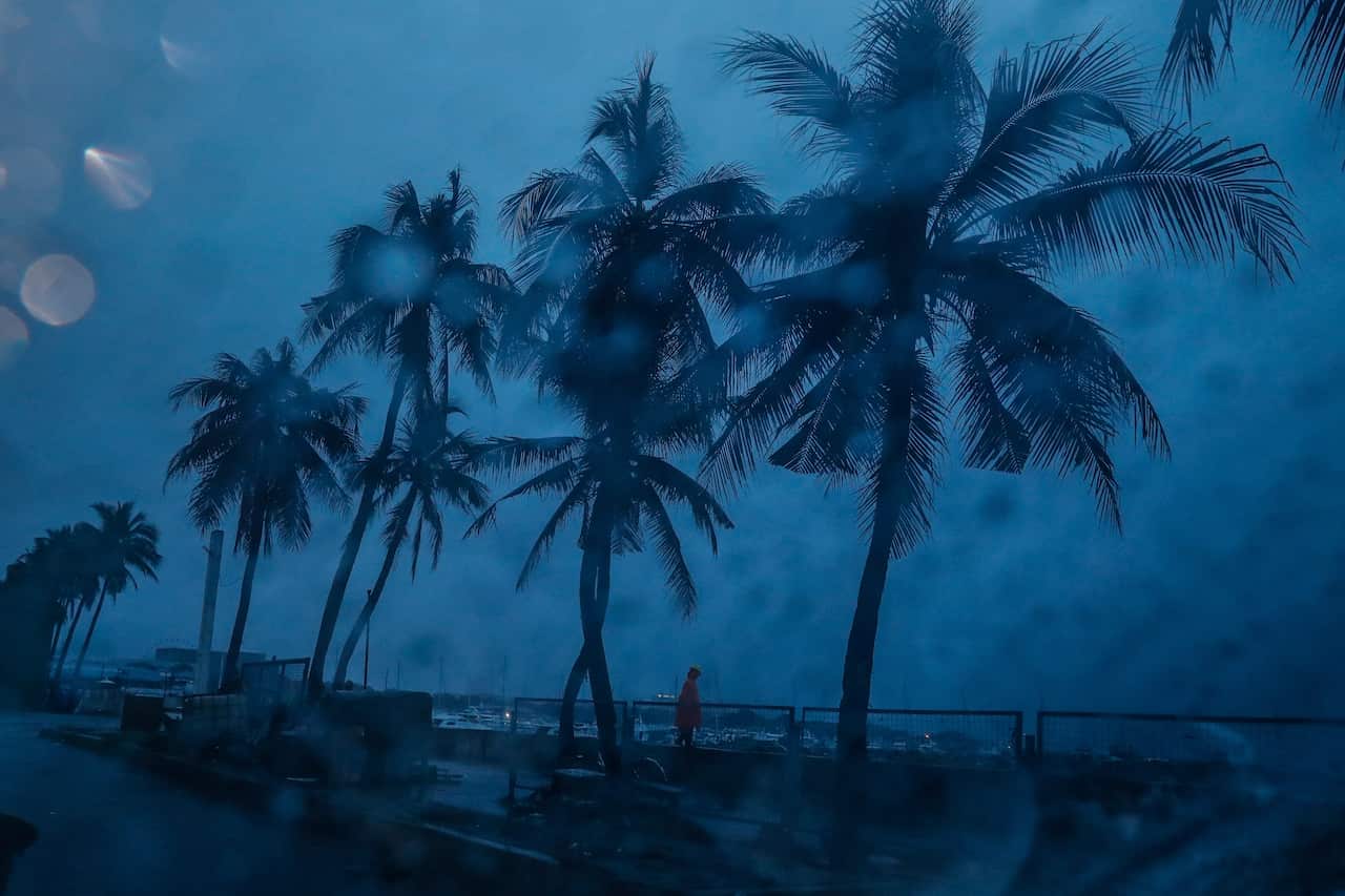 A man stands on the shore of Manila Bay in Manila