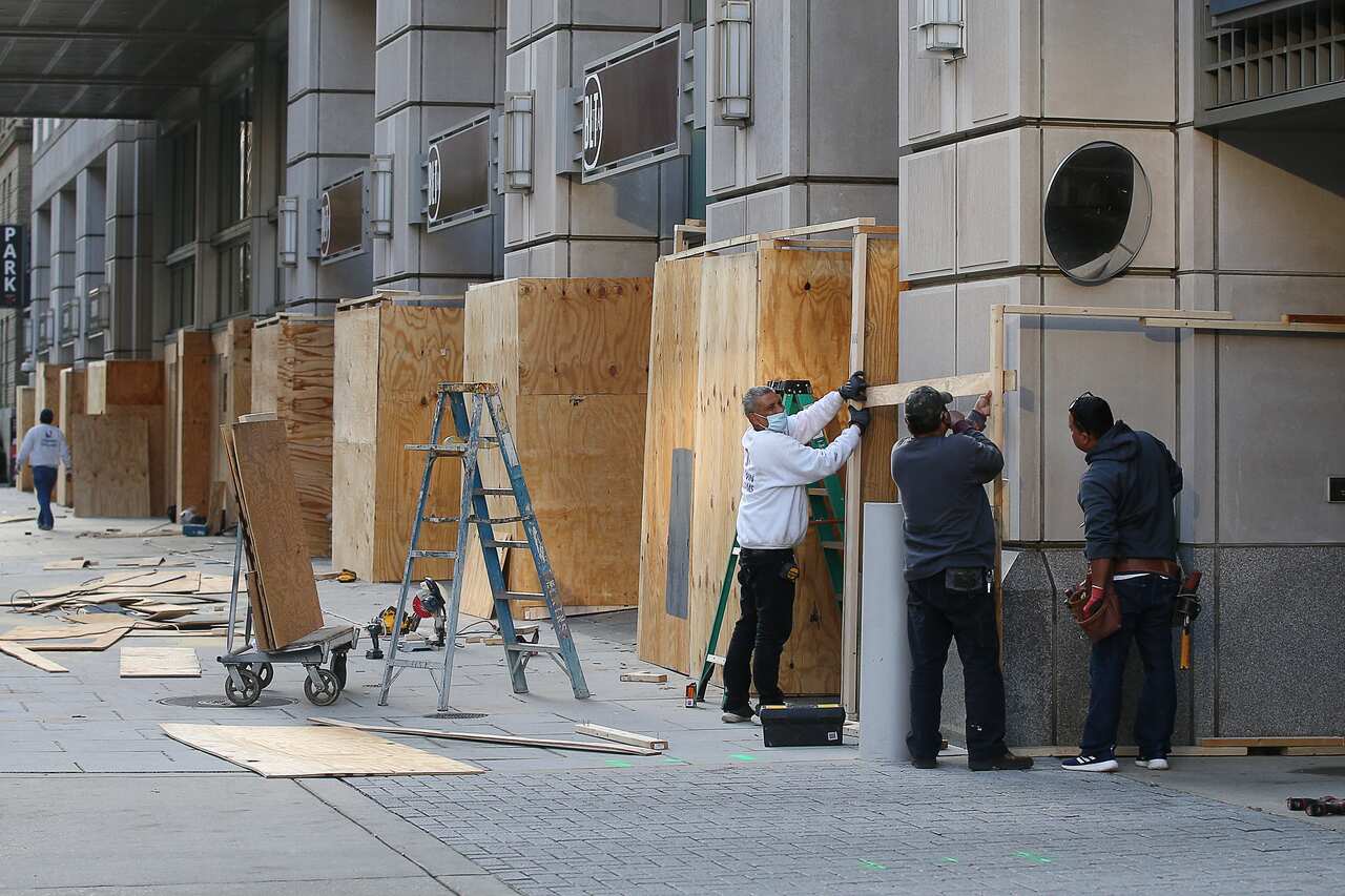 Owners fit the first floor windows of their Washington D.C. shops with protective wooden panels in case of street riots ahead of the 2020 presidential election.