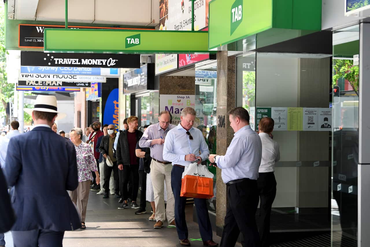 Punters are seen lining up outside a TAB ahead of the running of the Melbourne Cup, in Sydney, Tuesday, November 3, 2020. (AAP Image/Dan Himbrechts) NO ARCHIVING, EDITORIAL USE ONLY