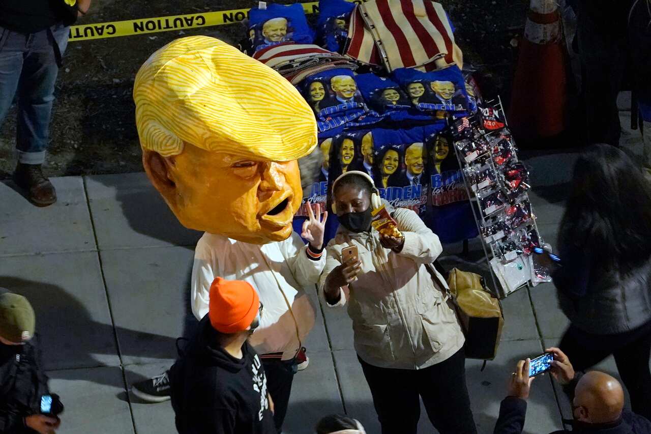 A person in a Donald Trump costume joins the protesters.