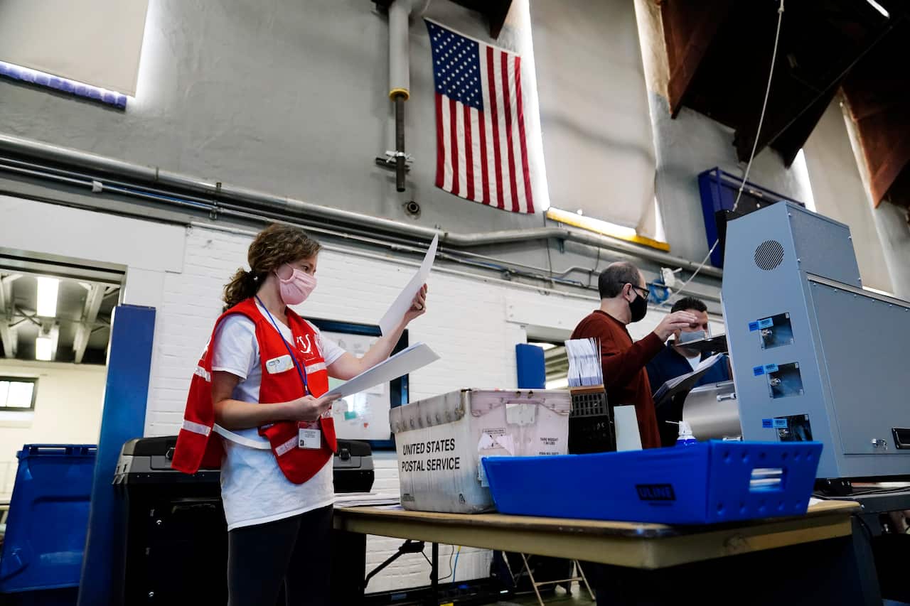 Pennsylvania election workers process mail-in and absentee ballots to scan for the 2020 general election in the United States at West Chester University.