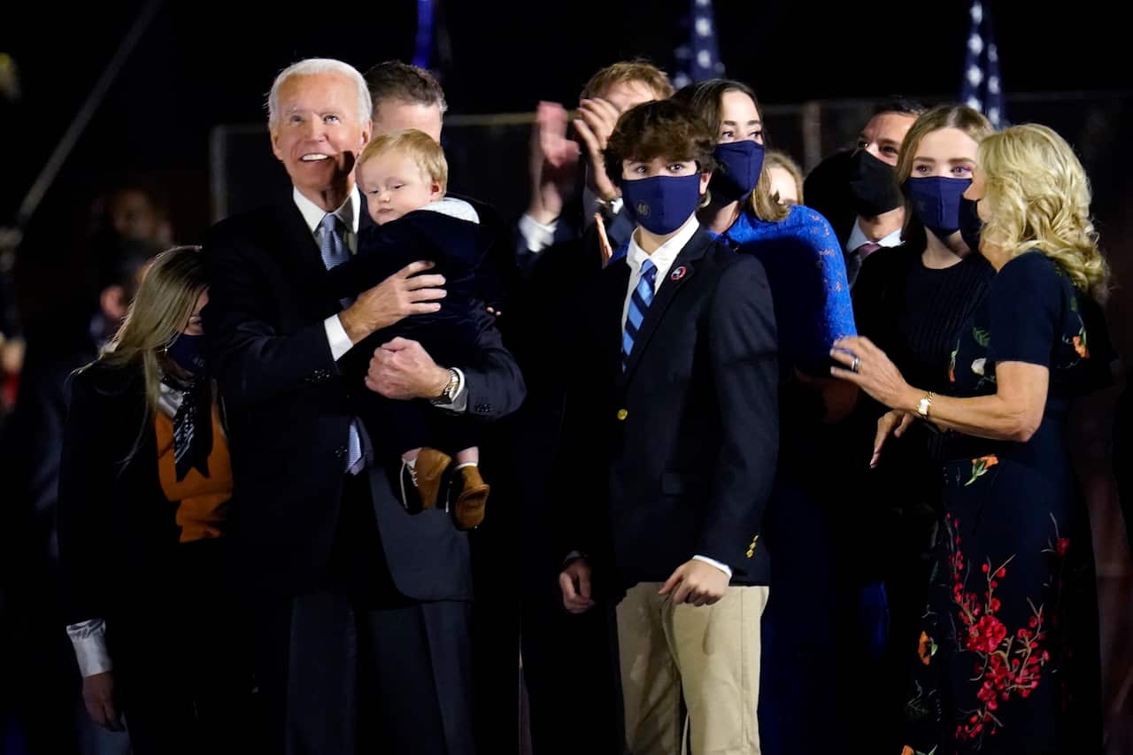 President-elect Joe Biden stands with Jill Biden and his family after his victory speech. 