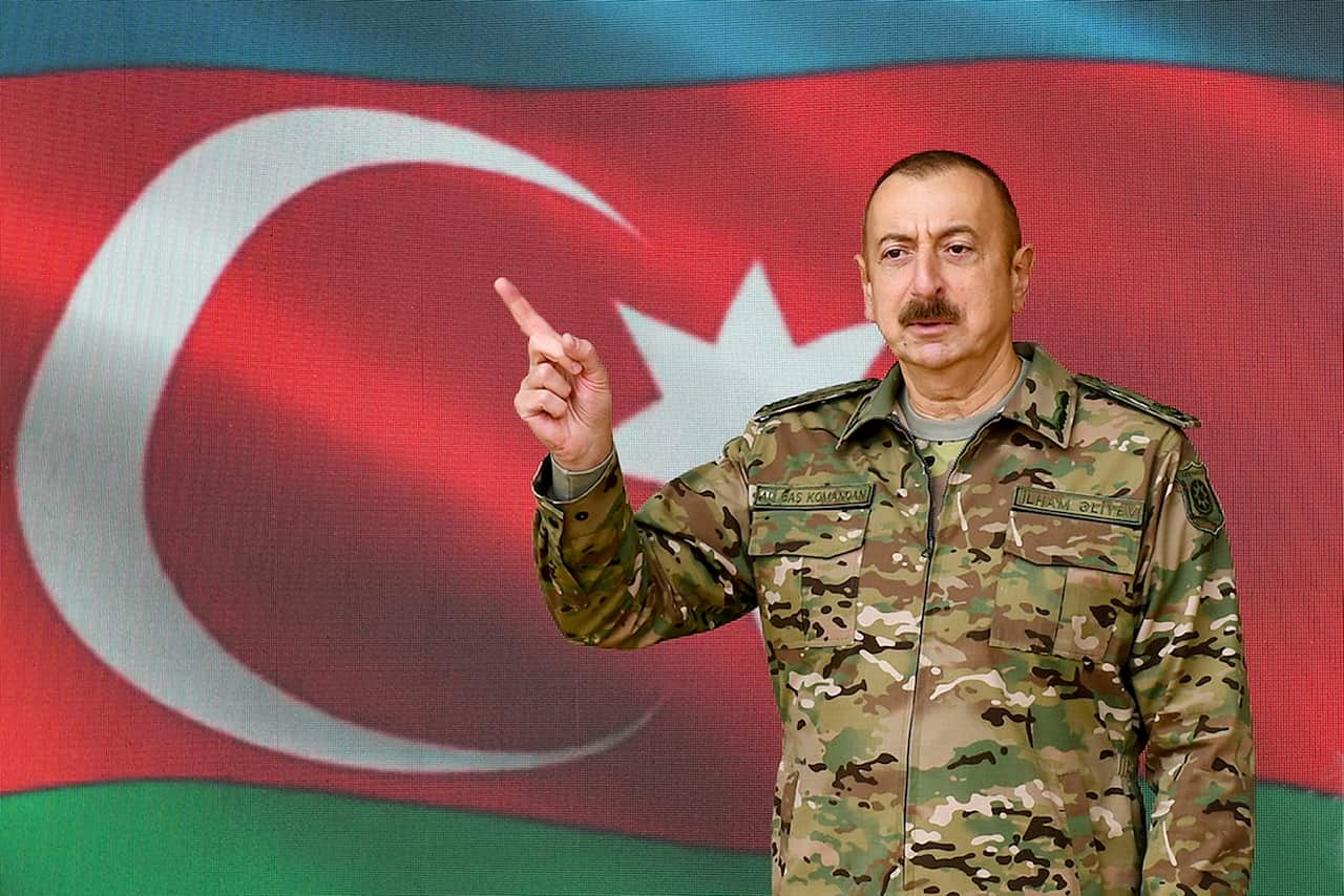 In this handout photo provided by the Azerbaijan's Presidential Press Office, Azerbaijani President Ilham Aliyev gestures as he addresses the nation in Baku.