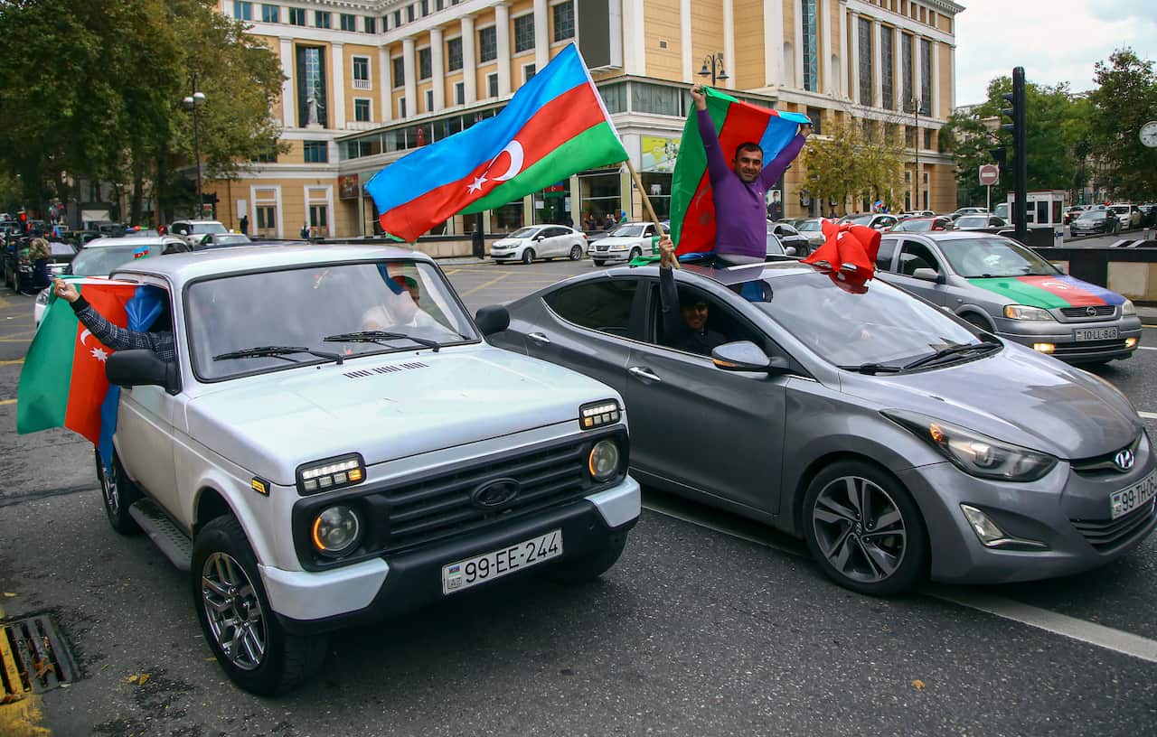 Azeri people celebrate the claimed recapture of the city of Shusha by Azerbaijani troops.