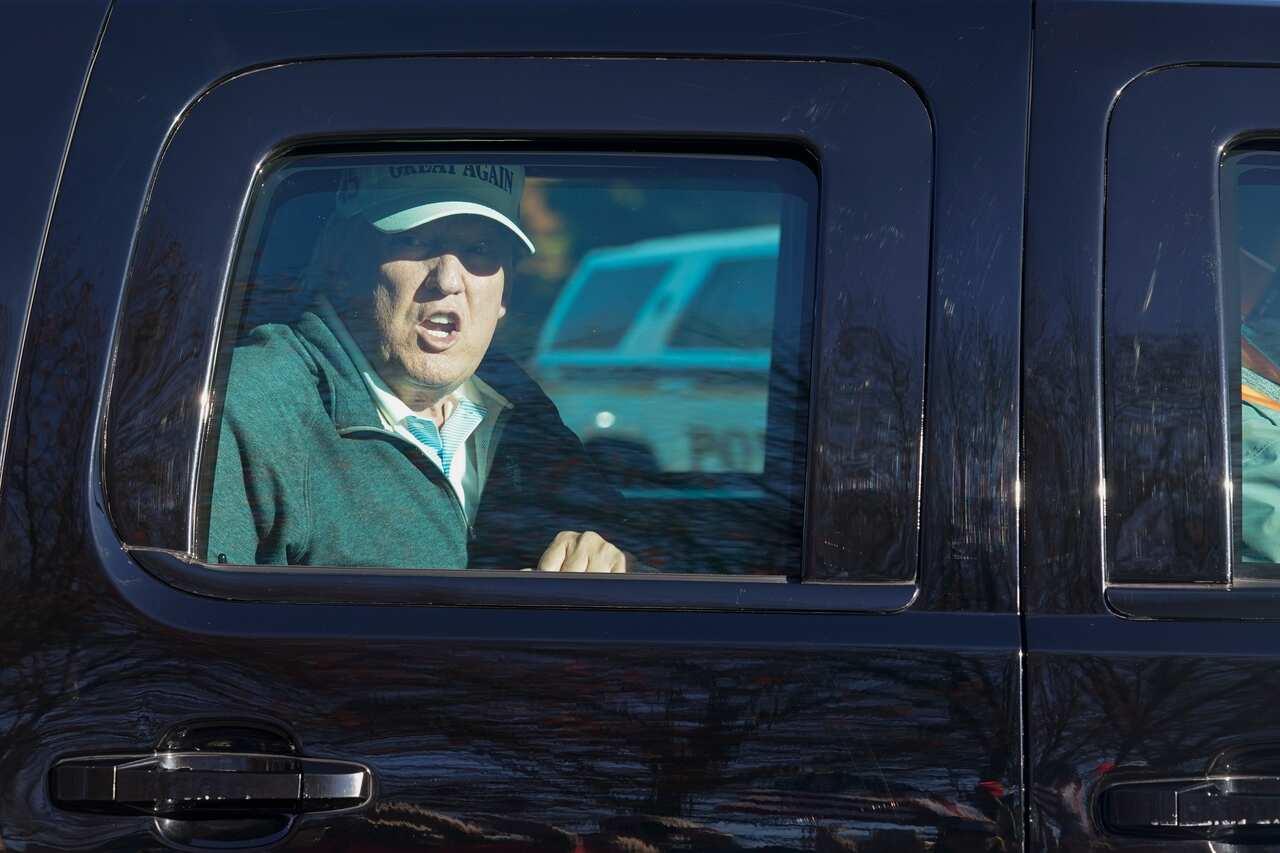President Donald Trump looks at supporters as he departs after playing golf at the Trump National Golf Club in Sterling Va., Sunday Nov. 8, 2020. (AP Photo/Steve Helber)