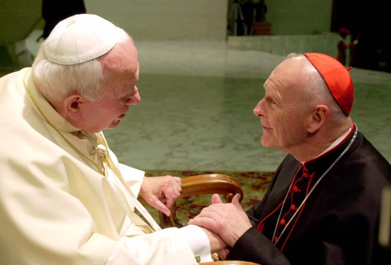 Cardinal Theodore McCarrick, archbishop of Washington, DC shakes hands with Pope John Paul II  at a ceremony at the Vatican on 21 February, 2001.