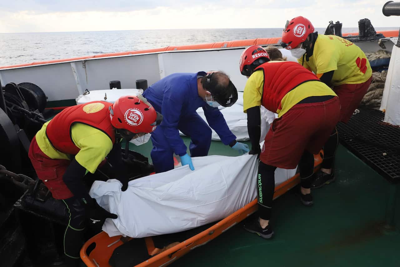 NGO Proactiva Open Arms members recover a dead body of a migrant in the Mediterranean sea.