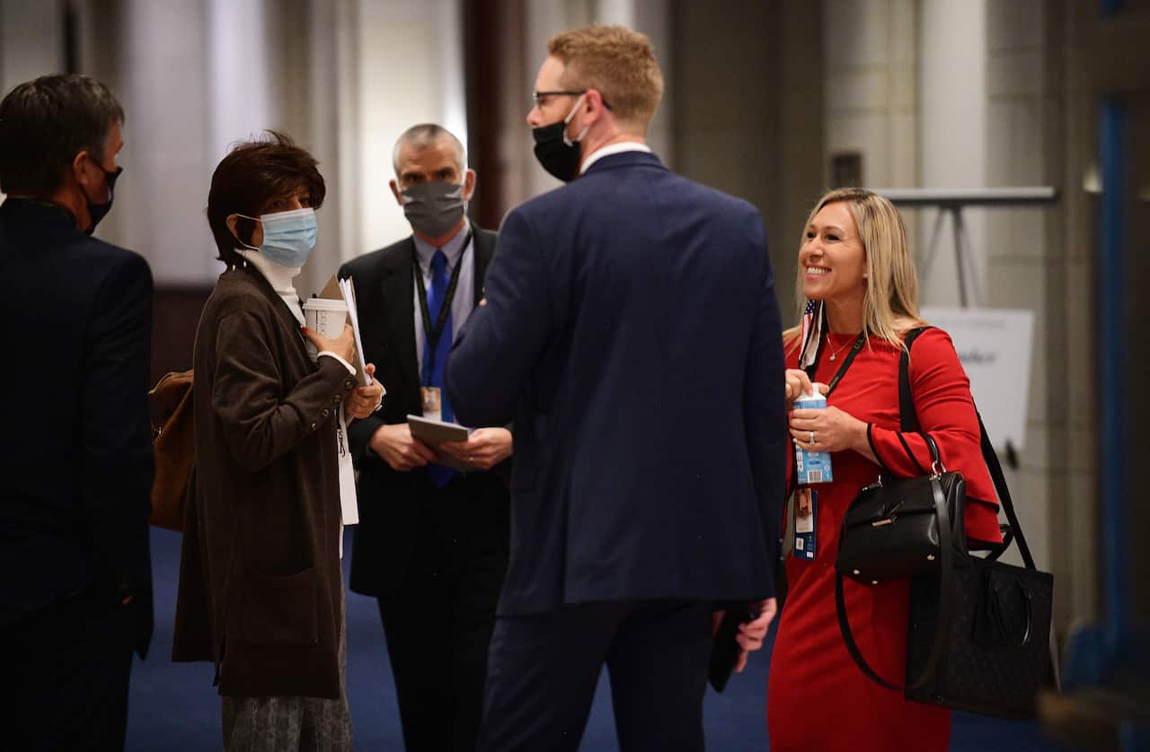 Marjorie Taylor Greene, right, joins other for a chat during Congressional orientation