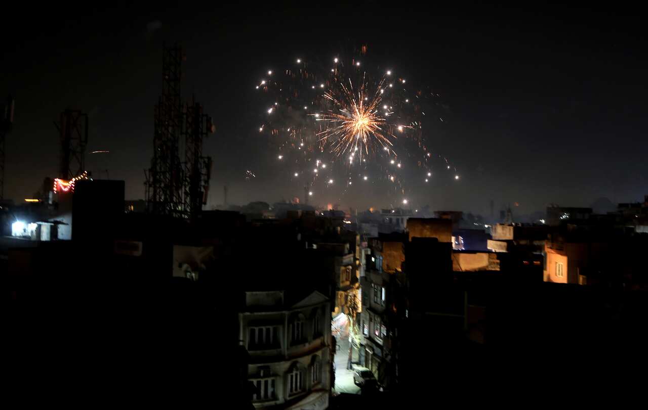 Indian people light fireworks on the occasion of the Diwali festival in Jammu, India, 14 November 2020. 