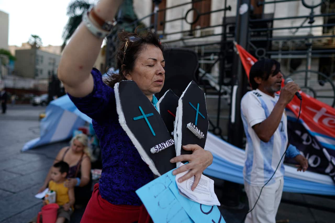 A demonstrator against abortion holds two fake coffins as she protests against the legalization of abortion. 