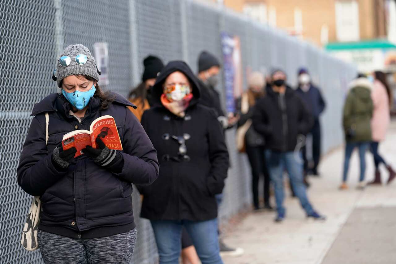 People wait in line outside a New York City COVID testing site in Brooklyn, New York, Thursday, 19 November, 2020.