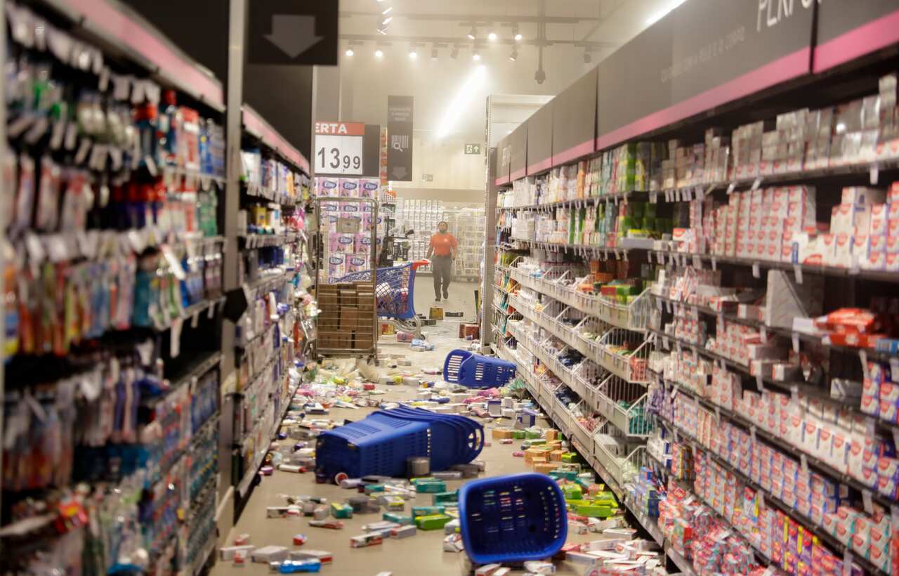 An employee stands inside a Carrefour supermarket in Sao Paolo during a protest against the murder of Black man Joao Alberto Silveira Freitas in Porto Alegre.