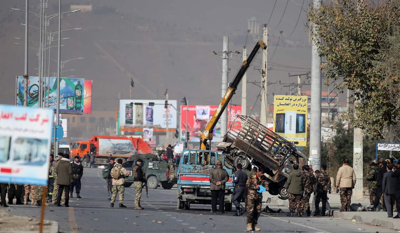 Security personnel inspect a damaged vehicle which was carrying and shooting rockets, in the aftermath of a rocket attack in Kabul, Afghanistan on 21 November. 