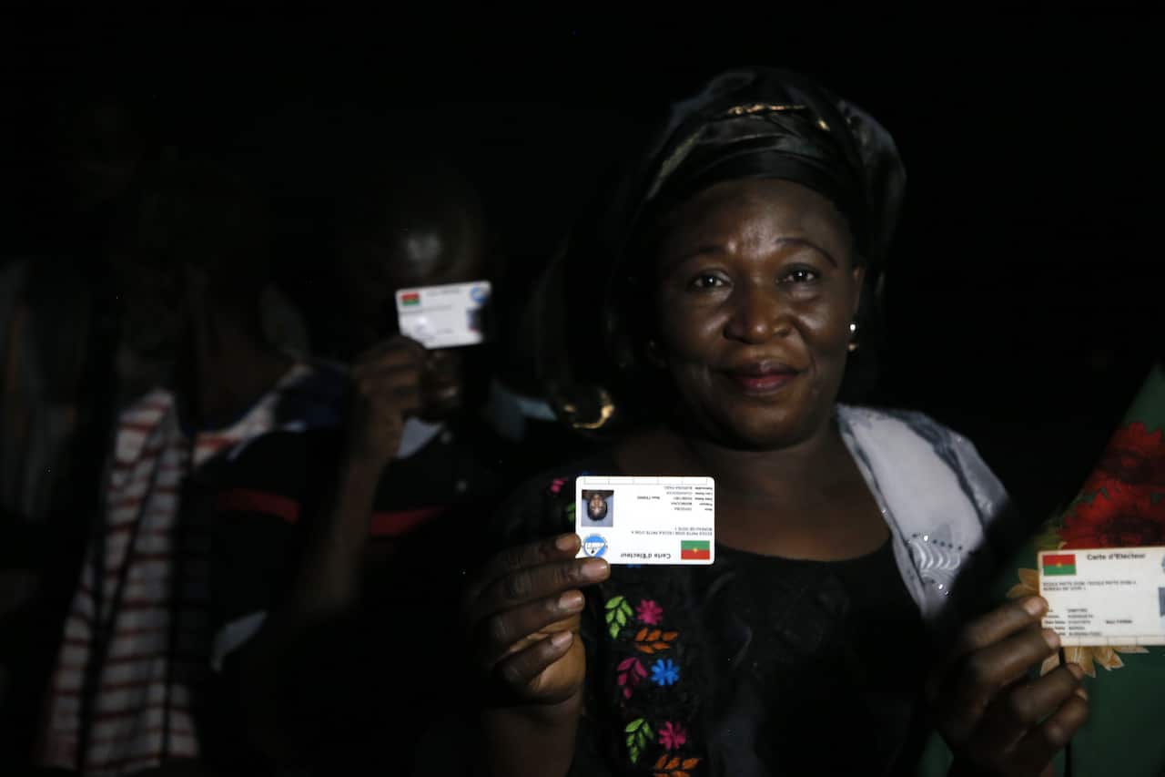 People line up to vote in Burkina Faso's presidential and legislative elections as polling stations open in Ouagadougou on 22 November, 2020. 