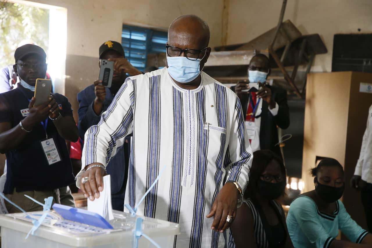 Incumbent President Roch Marc Christian Kabore casts his ballot in the presidential elections in Ouagadougou, Burkina Faso, 22 November 2020. 