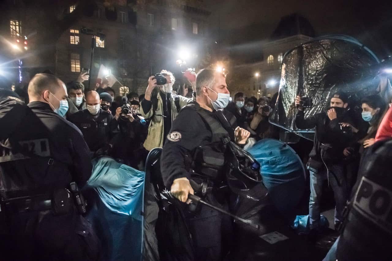 French police officers evacuate migrants with their tents from a new migrant camp in Paris’ Place de la Republique.