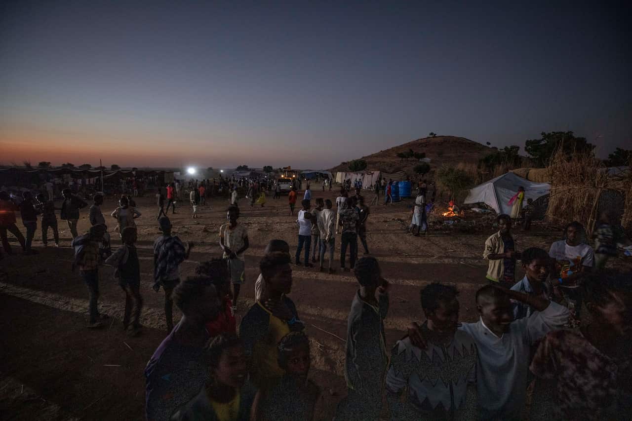 People who fled the conflict in Ethiopia's Tigray region walk at Umm Rakouba refugee camp in Qadarif, eastern Sudan.