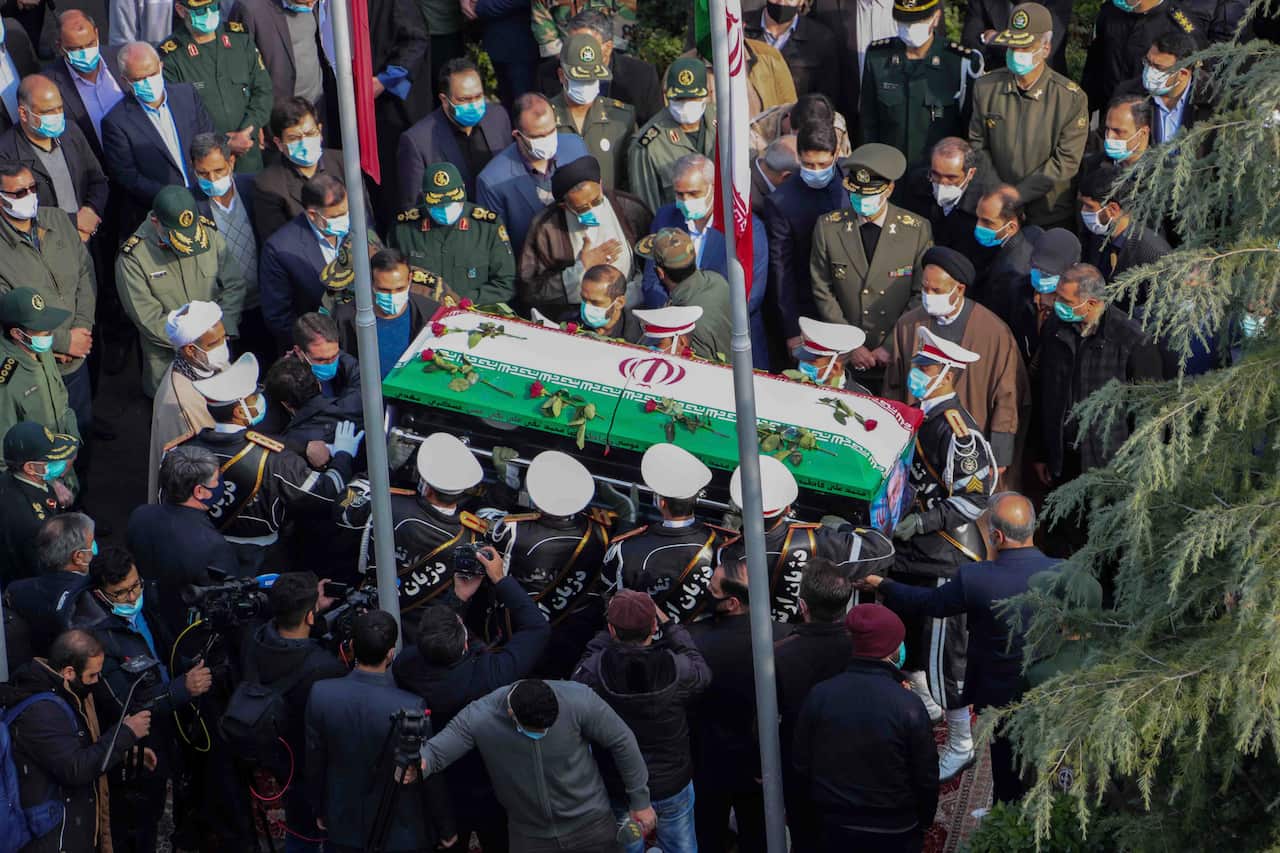 Iranian Defense Ministry, military personnel carry the flag draped coffin of Mohsen Fakhrizadeh.
