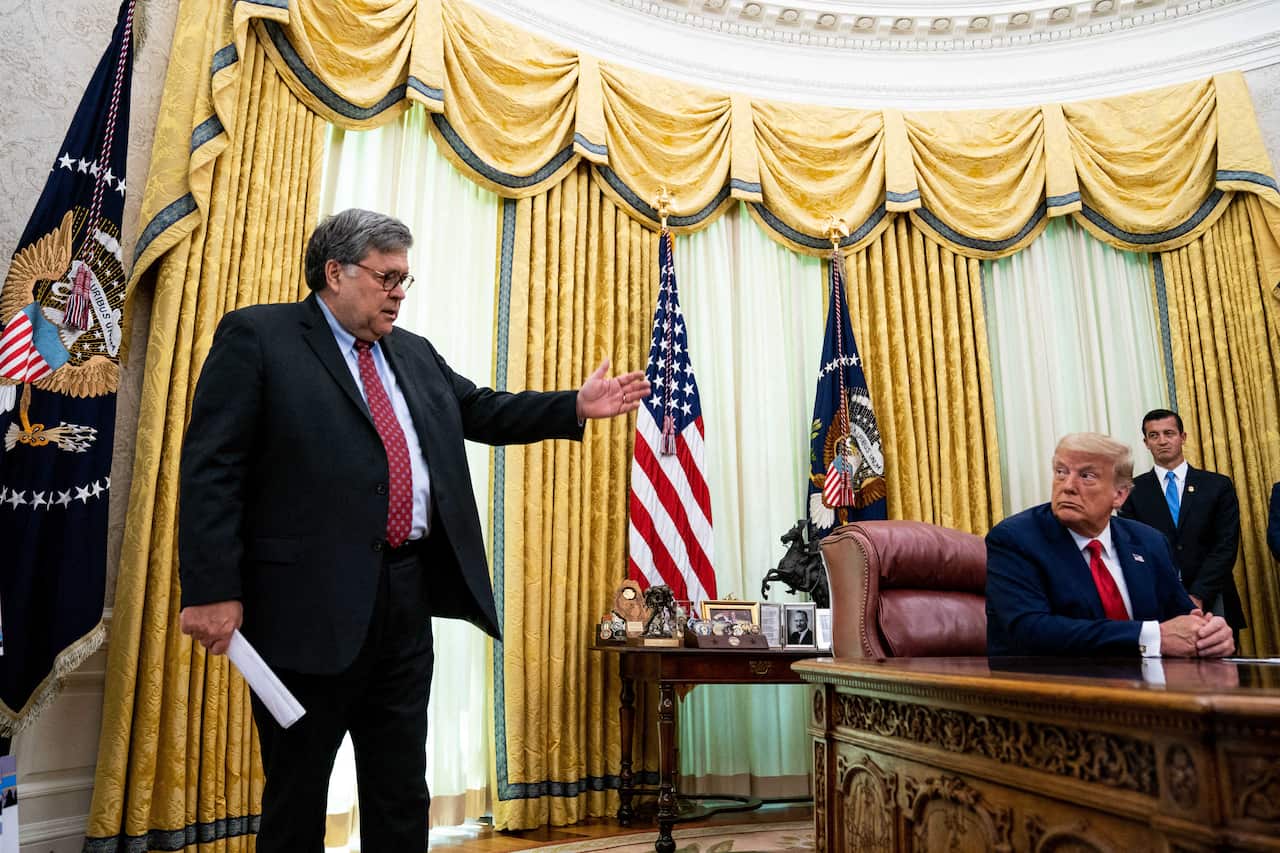 In this file photo from July 2020, President Donald Trump listens to Attorney General William Barr speak to reporters in the Oval Office of the White House.