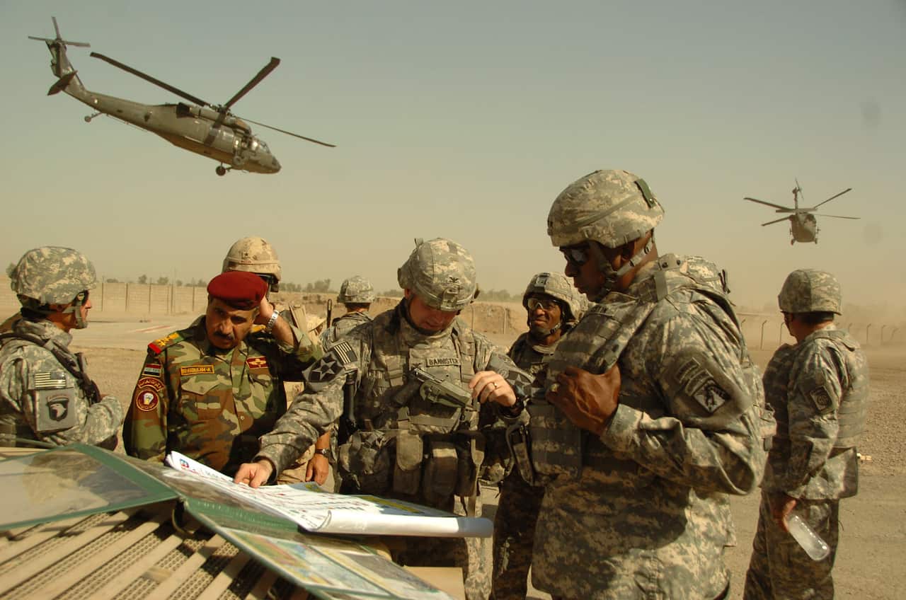 A 2007 file photo of of US Army Lt. General Lloyd J. Austin III (right) during a field meeting outside Baghdad, Iraq. 