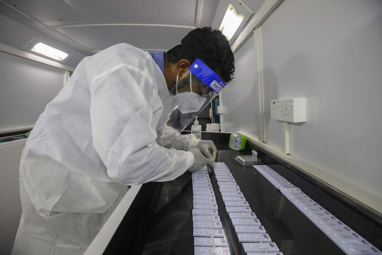 A Sri Lankan health officer performs COVID-19 Rapid Antigen Tests at a mobile laboratory.