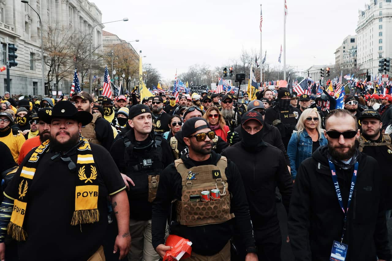 Members of the Proud Boys led by their chairman Enrique Tarrio march into Freedom Plaza, in Washington, on 12 December. 