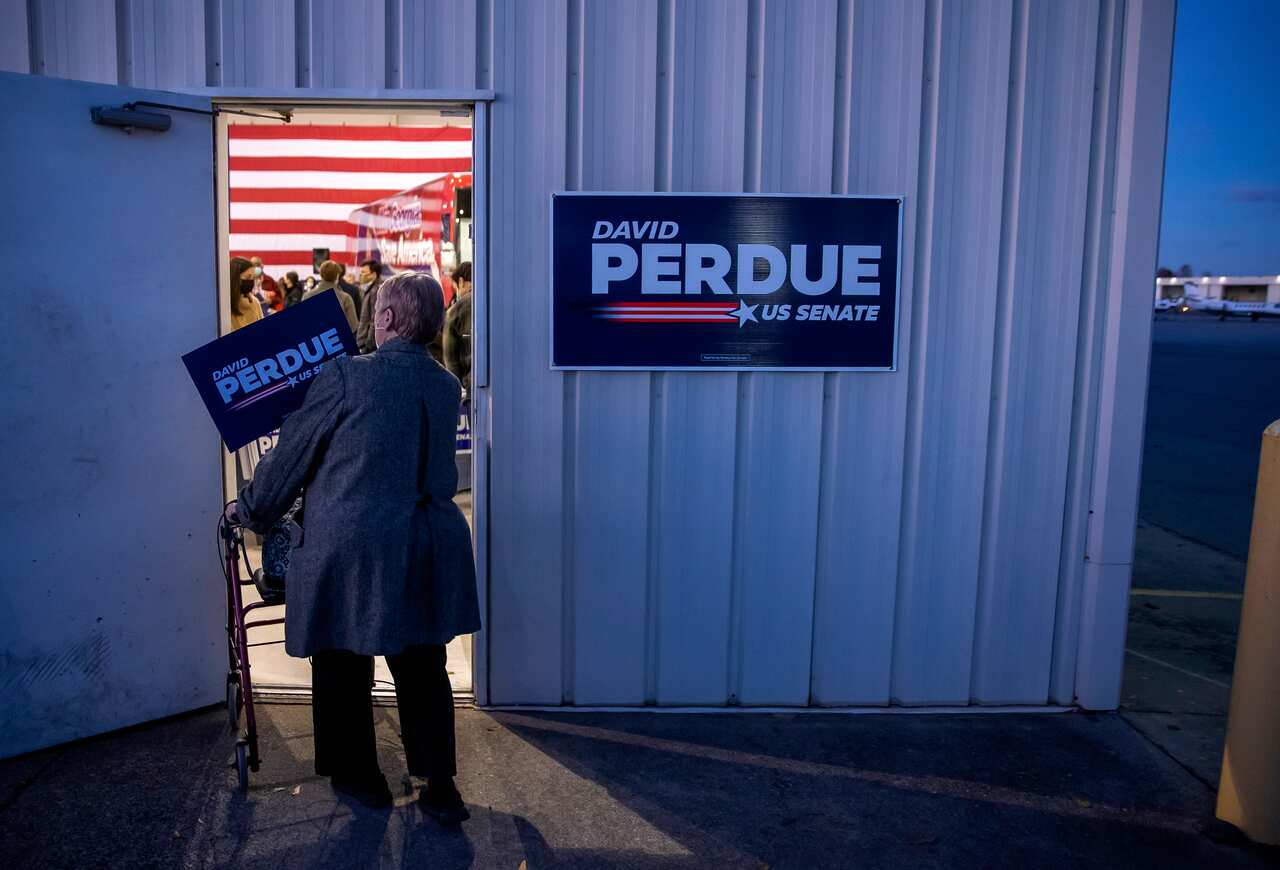 Supporters arrive to hear from US Republican Senator for Georgia David Perdue during the first day of early voting for the US Senate runoff election in Atlanta.