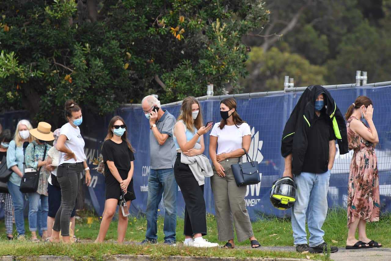 People line up for COVID-19 testing at Mona Vale Hospital's walk-in clinic in Sydney on Thursday.