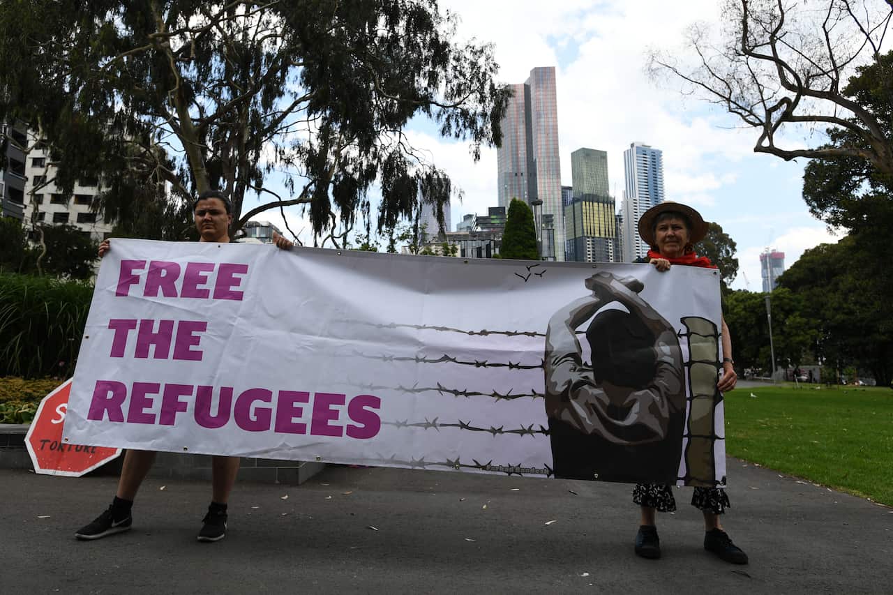 Protesters are seen outside the Park Hotel in Carlton, Melbourne on 17 December, 2020. 