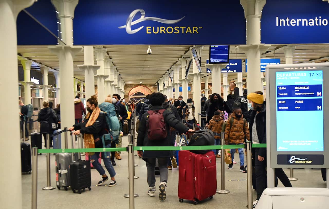 Travellers at Kings Cross St Pancras train station queue to board trains to Paris in London.