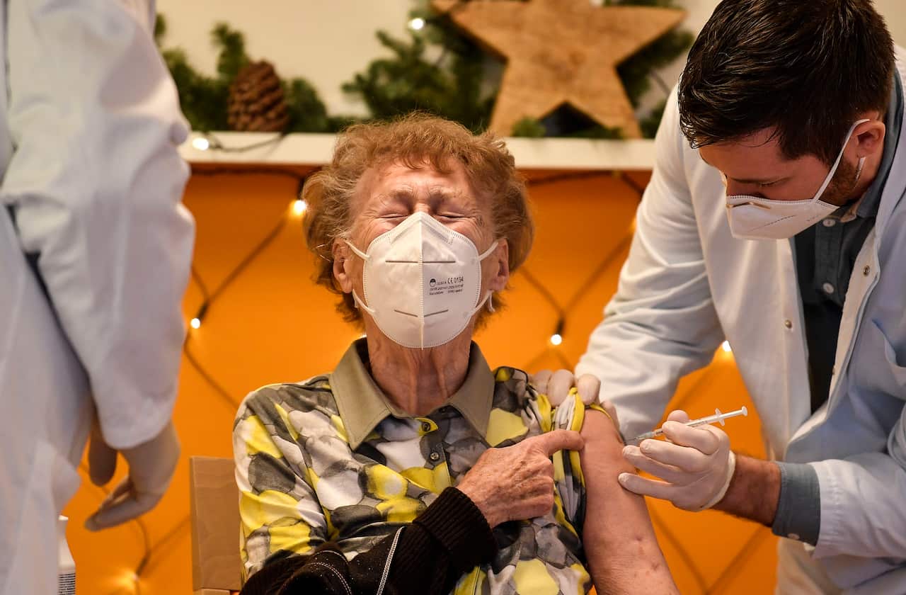 A resident of a nursing home gets an injection of the COVID-19 vaccine in Cologne, Germany.