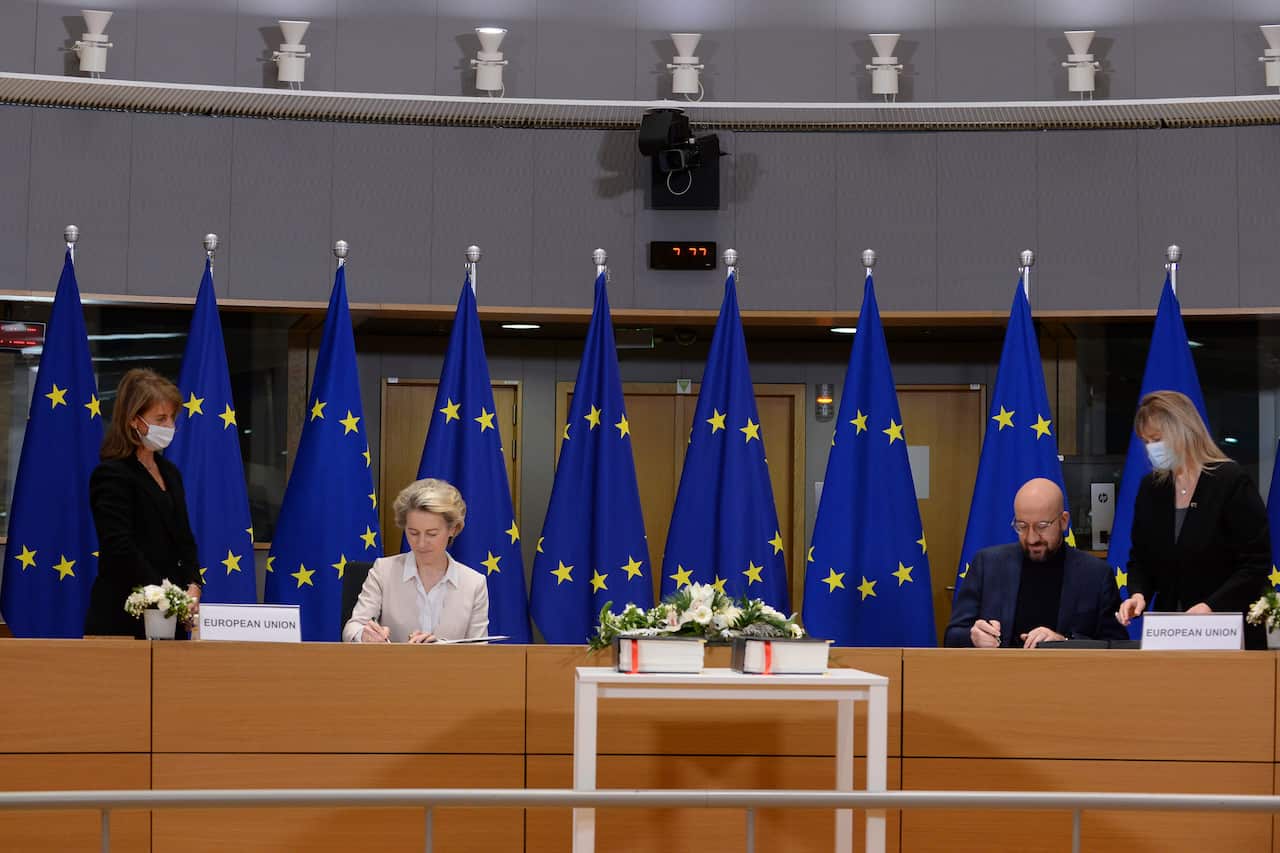 European Commission President Ursula von der Leyen and European Council President Charles Michel sign the EU-UK Trade and Cooperation Agreement.