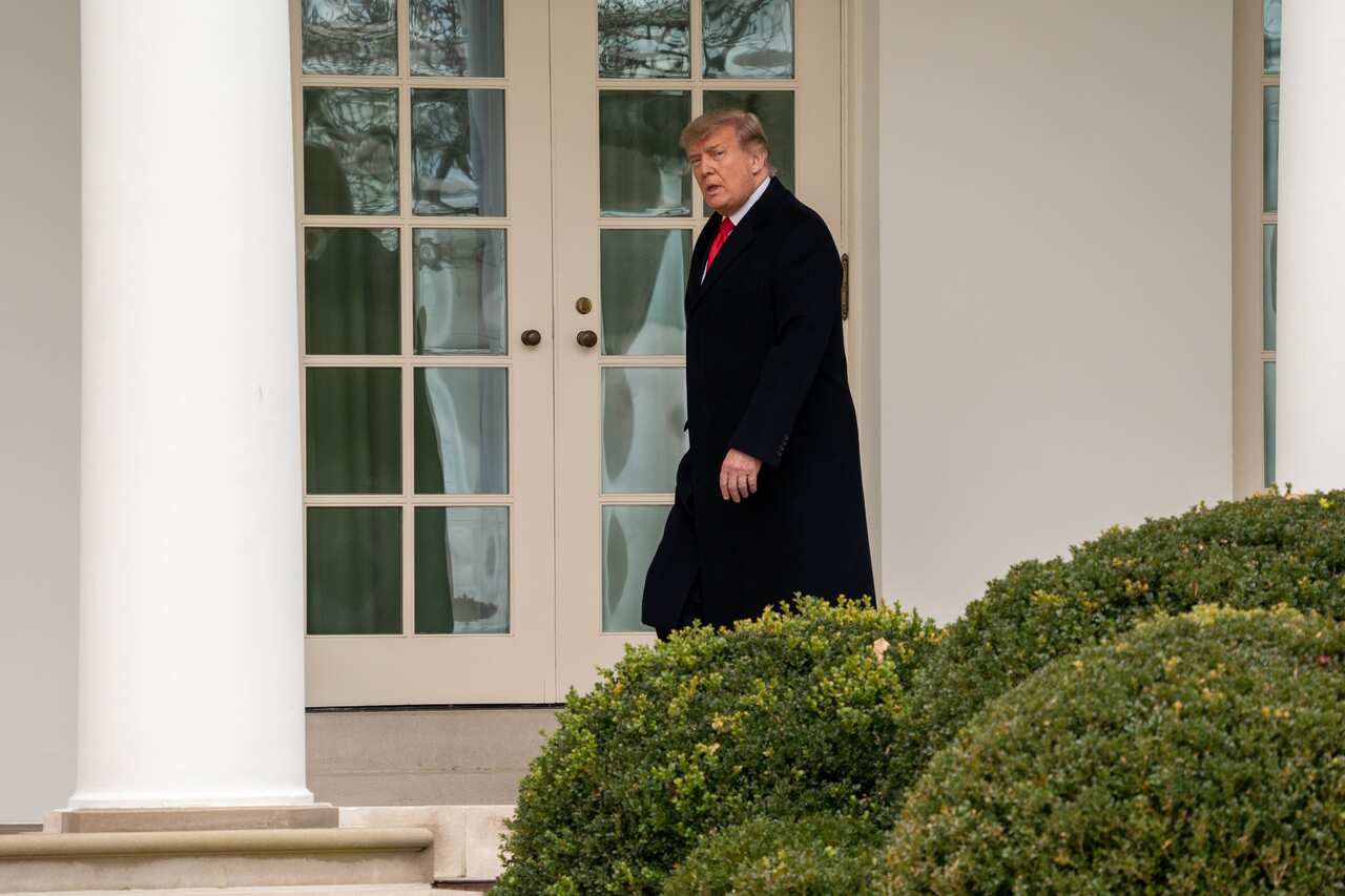 US President Donald Trump walks down the colonnade after returning from his Florida vacation early at the White House on 31 December, 2020. 