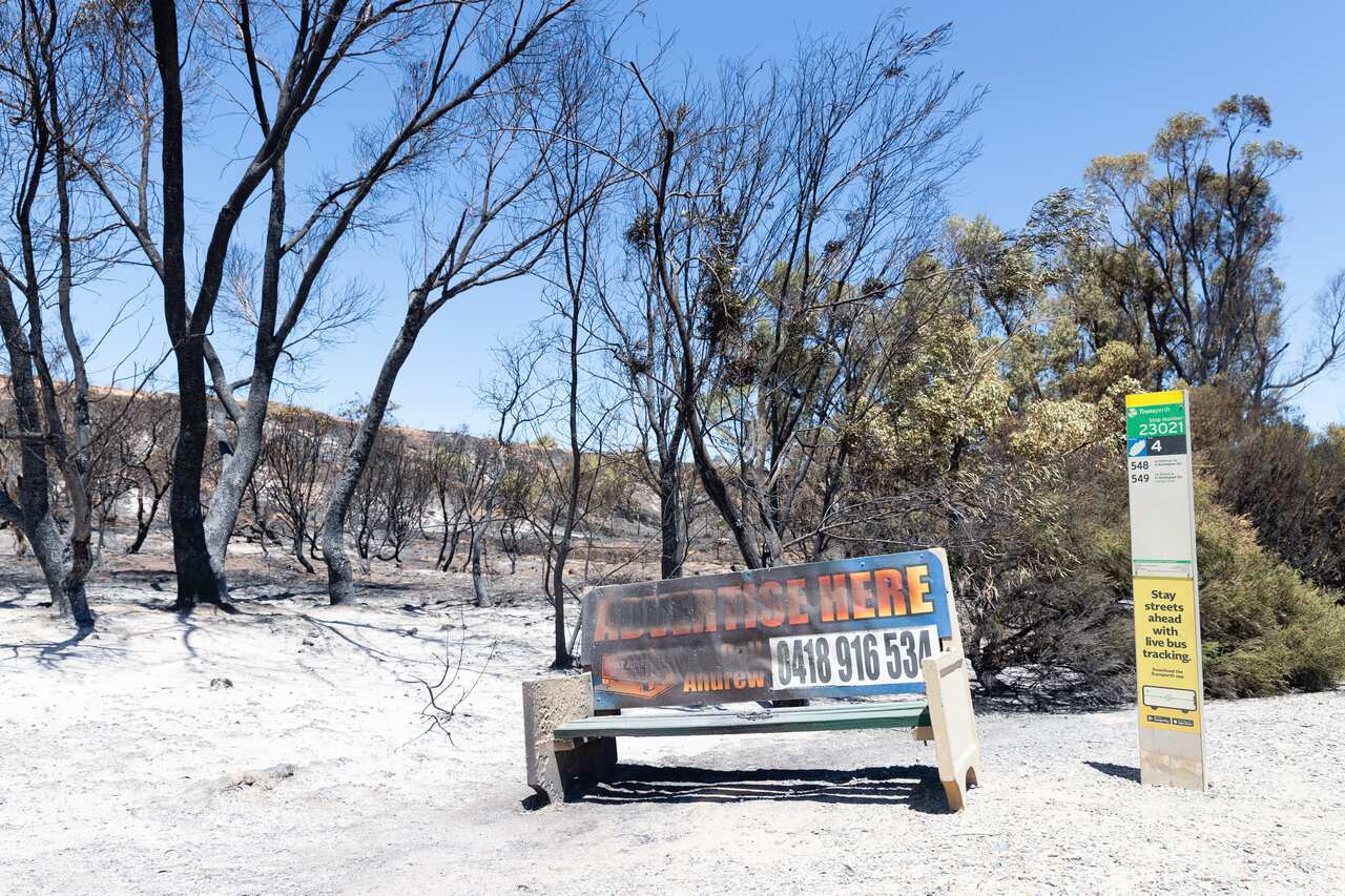 A bushfire damaged bus stop is seen on Patterson Road in Kwinana, south of Perth.
