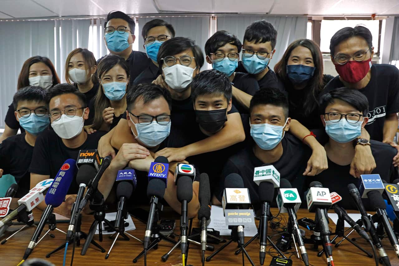 Pro-democracy activists elected from unofficial pro-democracy primaries, including Joshua Wong, left, attend a press conference in Hong Kong on 15 July, 2020. 