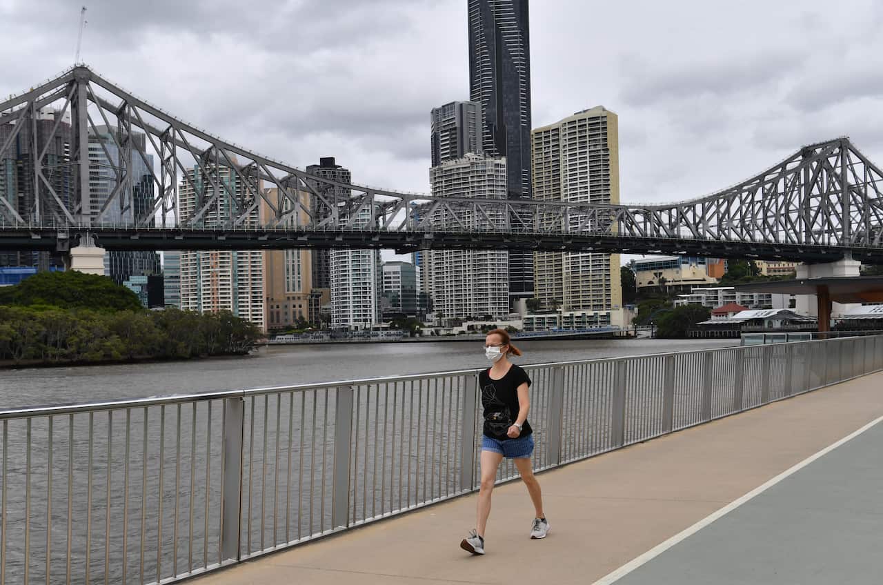 A women is seen walking in Brisbane, on Saturday, 9 January, 2021, as residents faced a mandatory weekend lockdown. 