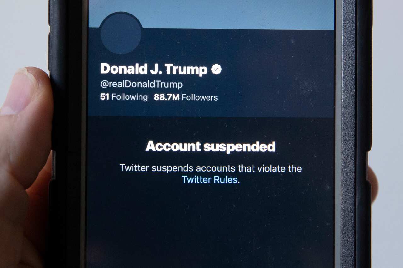 A mobile phone displays the suspended status of the Twitter account of US President Donald Trump.