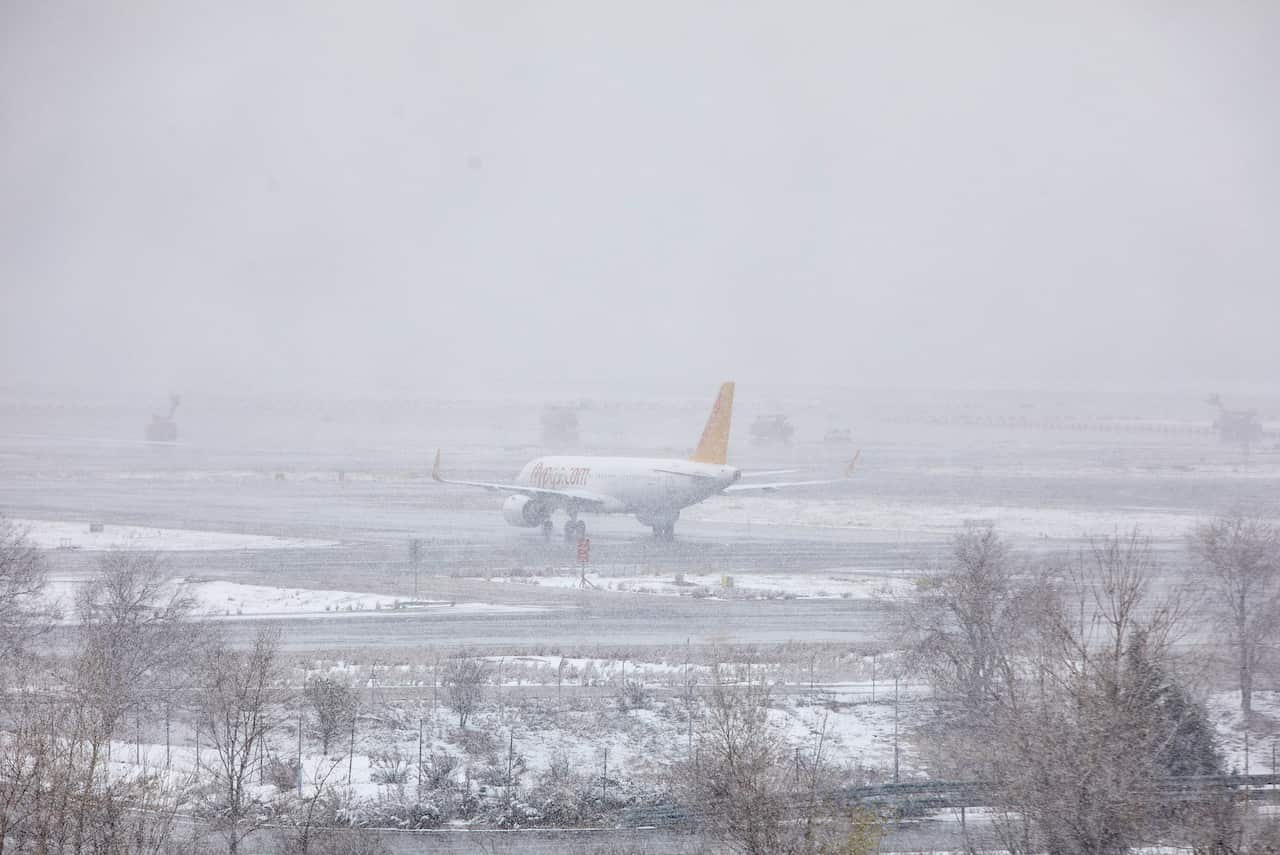 A passenger plane is seen on the ground of the Madrid airport during the heavy snowfall